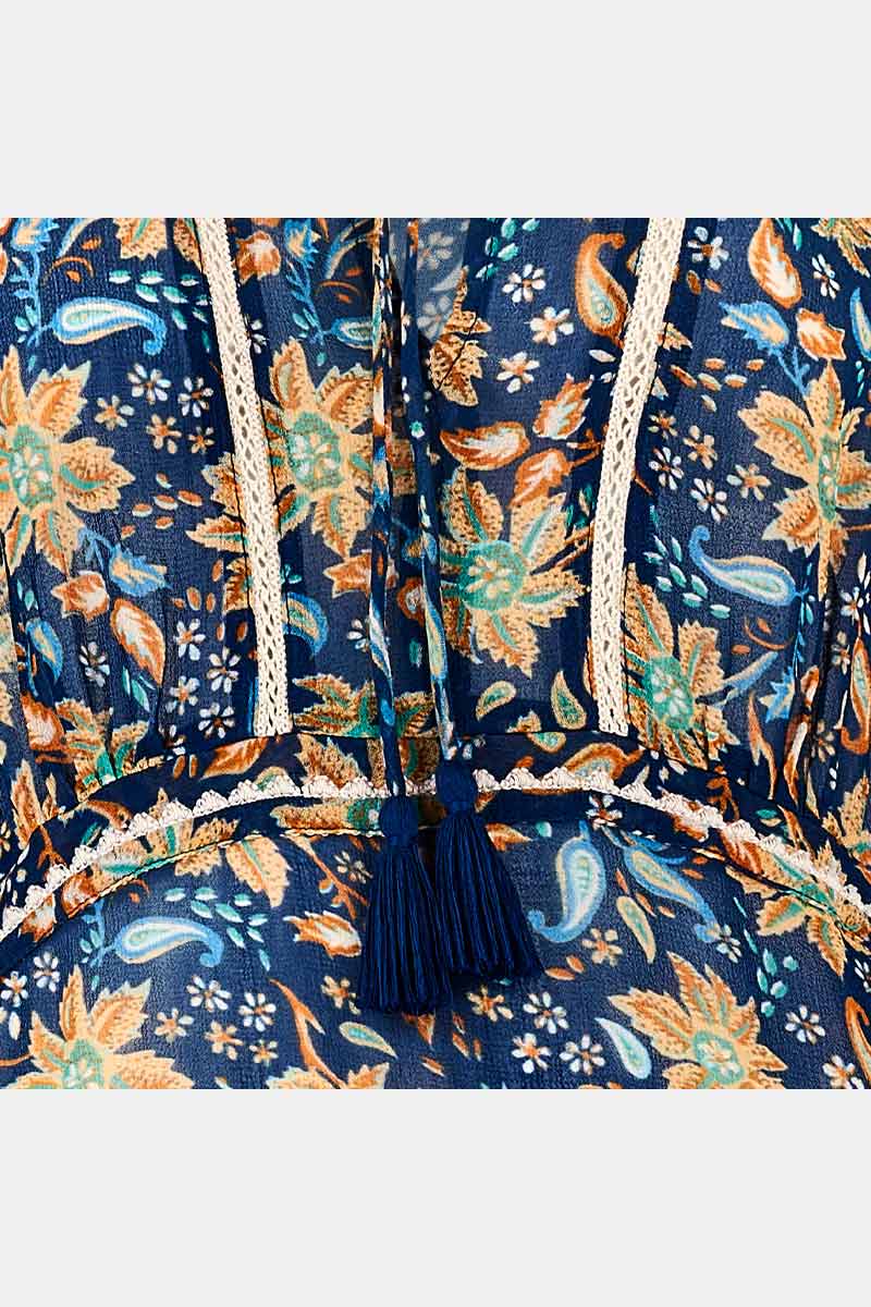 Detail view of lace trims and tie tassles. East Carly navy and orange printed floral dress.