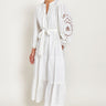 Model wears East Heritage Bridget White Organic Cotton Embroidered Dress, hand in pocket