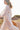Model wears East Heritage Bridget White Organic Cotton Embroidered Dress