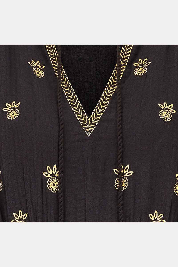 Detail view of Gabriella black dress with gold embroidery.
