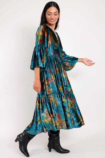 Model wears Lucille teal paisley printed velvet dress by east.co.uk