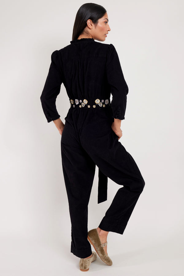 EAST. Model wears Beverley black jumpsuit with silver and gold bird embroidery.