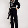 EAST. Model wears Beverley black jumpsuit with silver and gold bird embroidery.