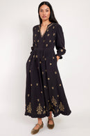 Model wears Gabriella black dress with gold embroidery by east.co.uk