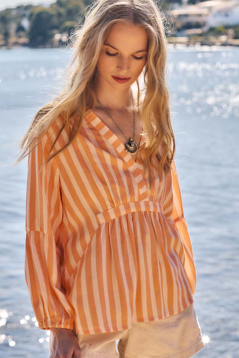 Model wears East Maeve Stripe Top on the beach