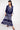 Model wears East Chrissie Batik Navy Satin Dress