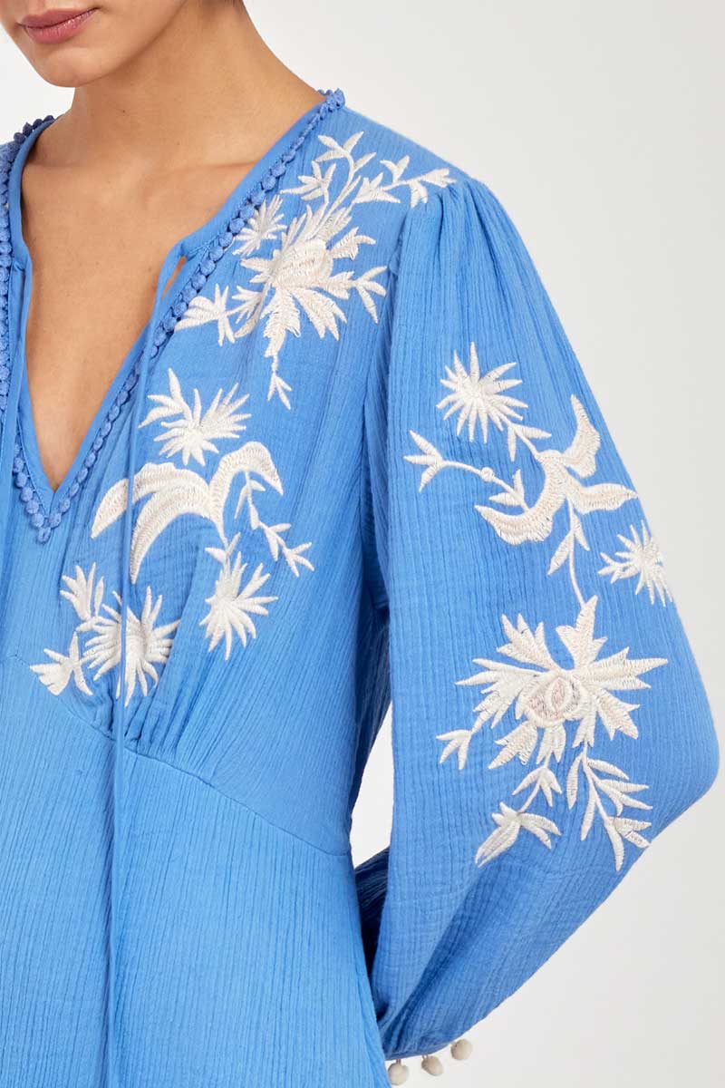 Close up of model wearing East Fern Embroidered Blue Cotton Gauze Dress