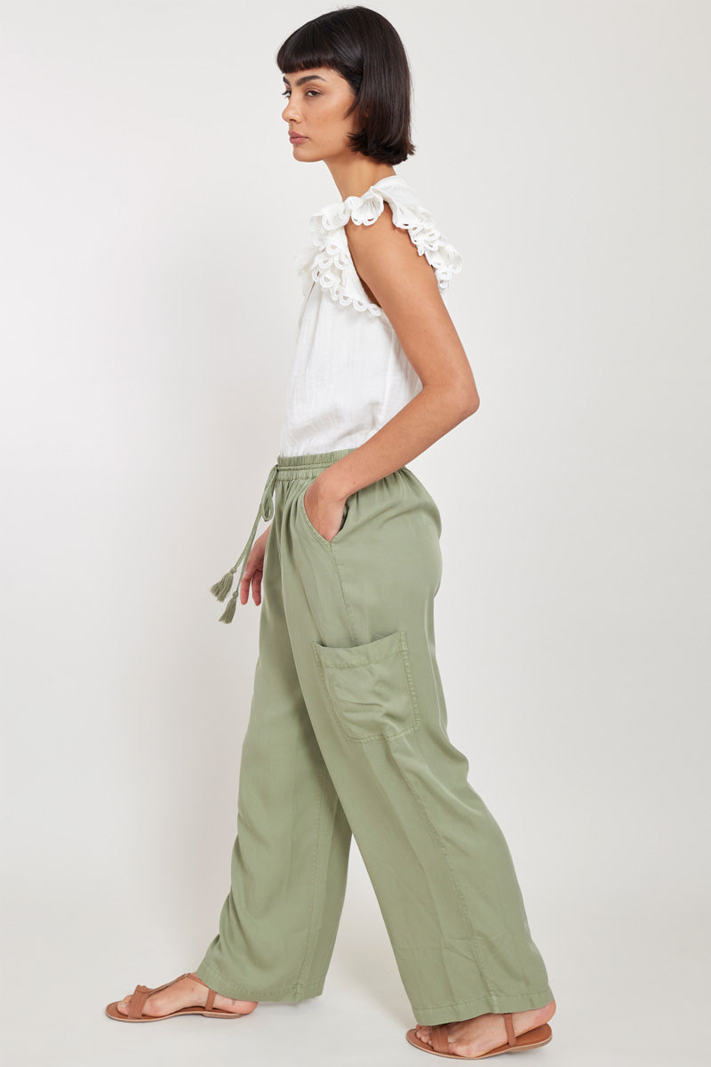 Side view of model wearing East Sage Pocket Trousers