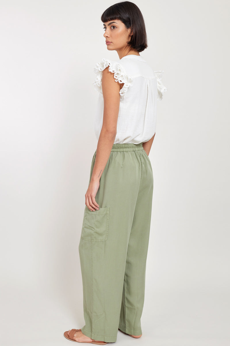 Back view of model wearing East Nia Sage Pocket Trousers
