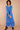Model wearing Harriet Blue Georgette Foil Dress by East.co.uk