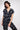 Model wearing Nimbus Black Batik Jumpsuit by East.co.uk